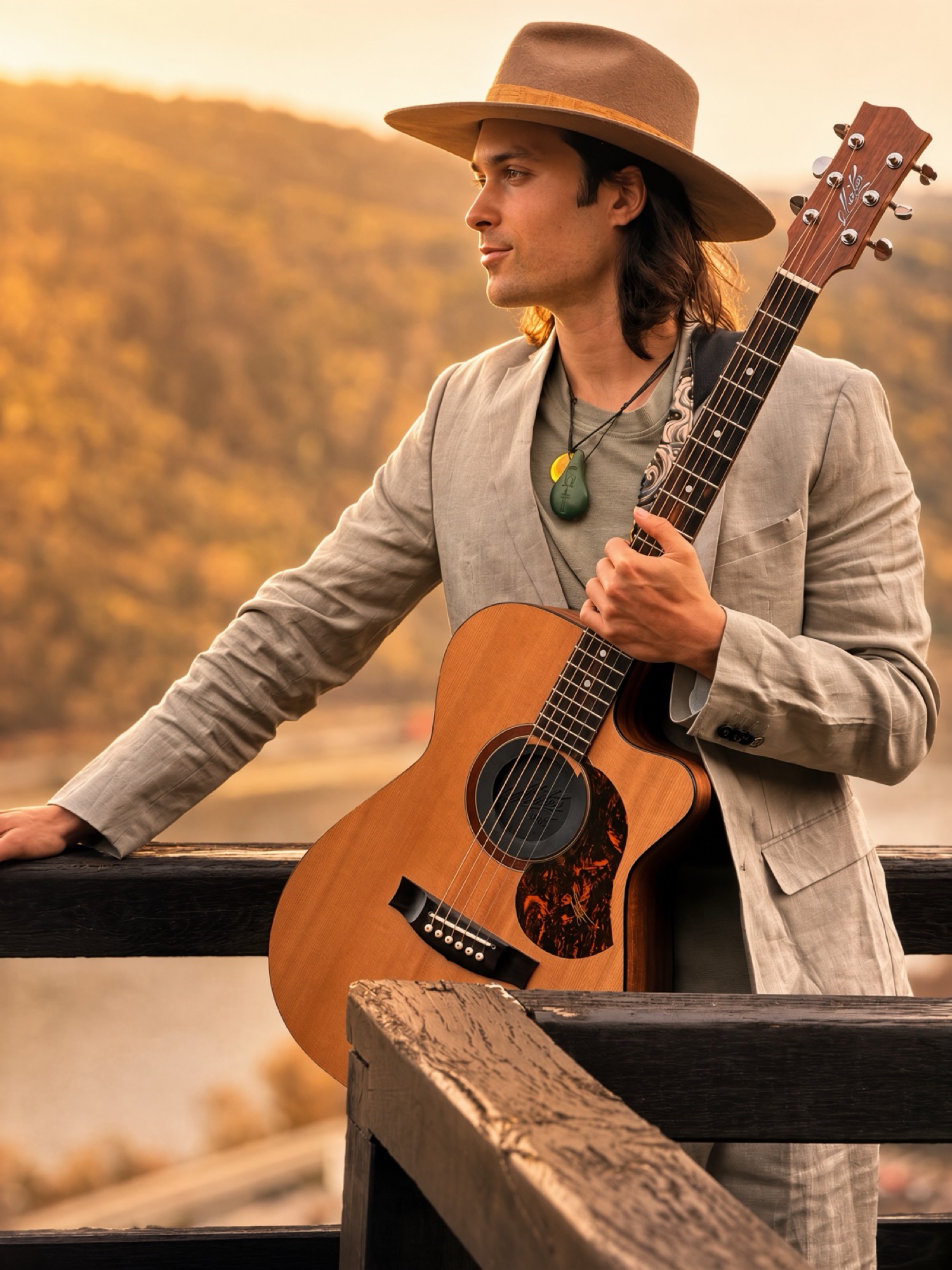 Luke Greenstone mit Gitarre an einem Geländer, Blick in die Landschaft